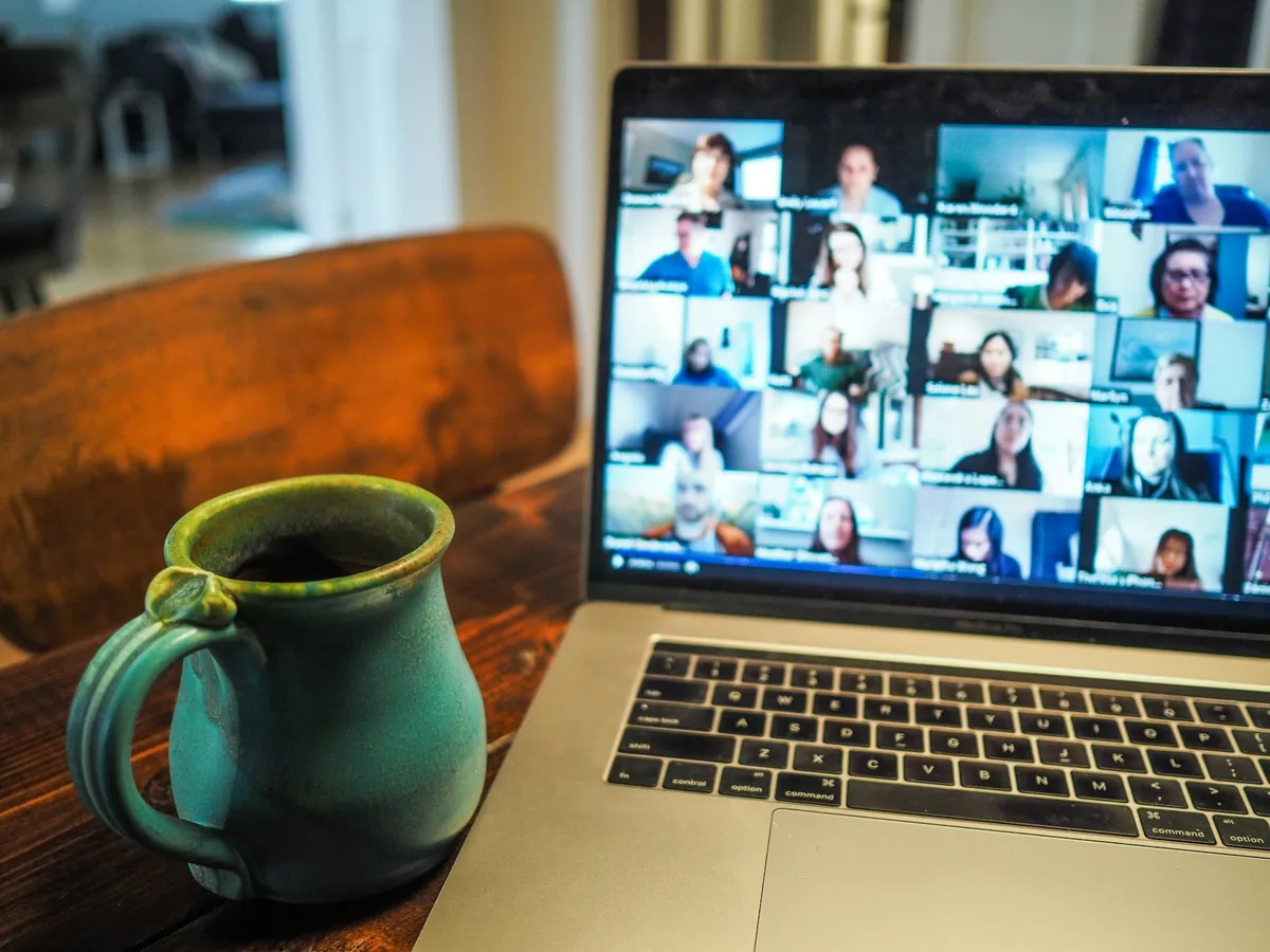 A laptop showing a video call with a team