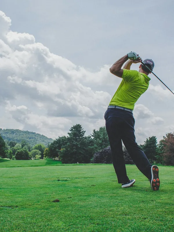 A golfer at the top of a swing
